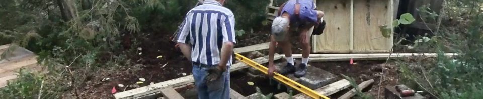 Pressure treated foundation. This assistant was responsible for the digging the hole and building the foundation.